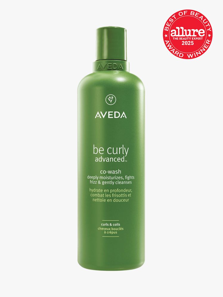 Aveda Be Curly Advanced CoWash in branded green bottle with cap on light gray background with red Allure Best of Beauty...
