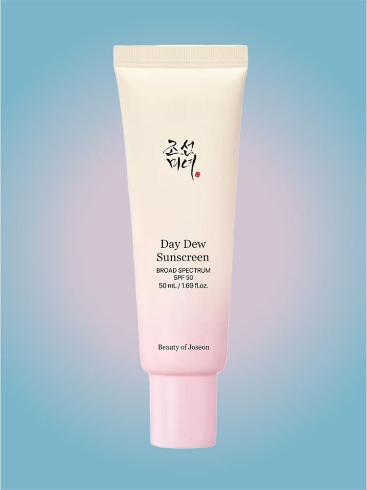 Beauty of Joseon Day Dew Sunscreen in branded tube component on a pink and blue background