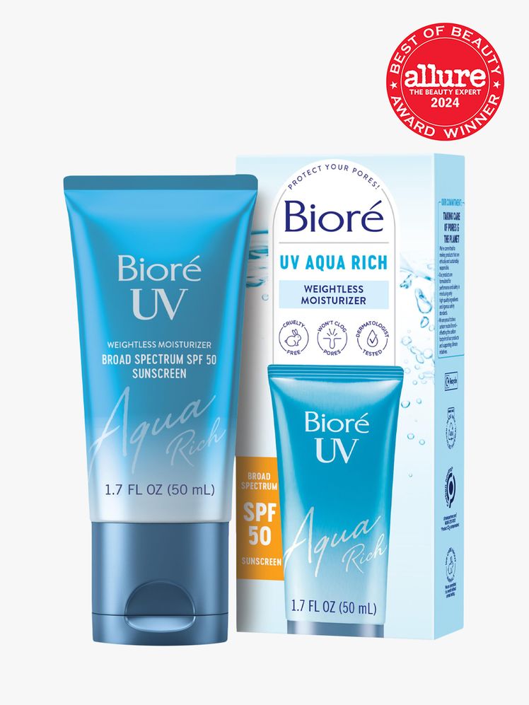 sunscreen in branded blue tube next to branded box packaging on light gray background with red and white 2024 allure...