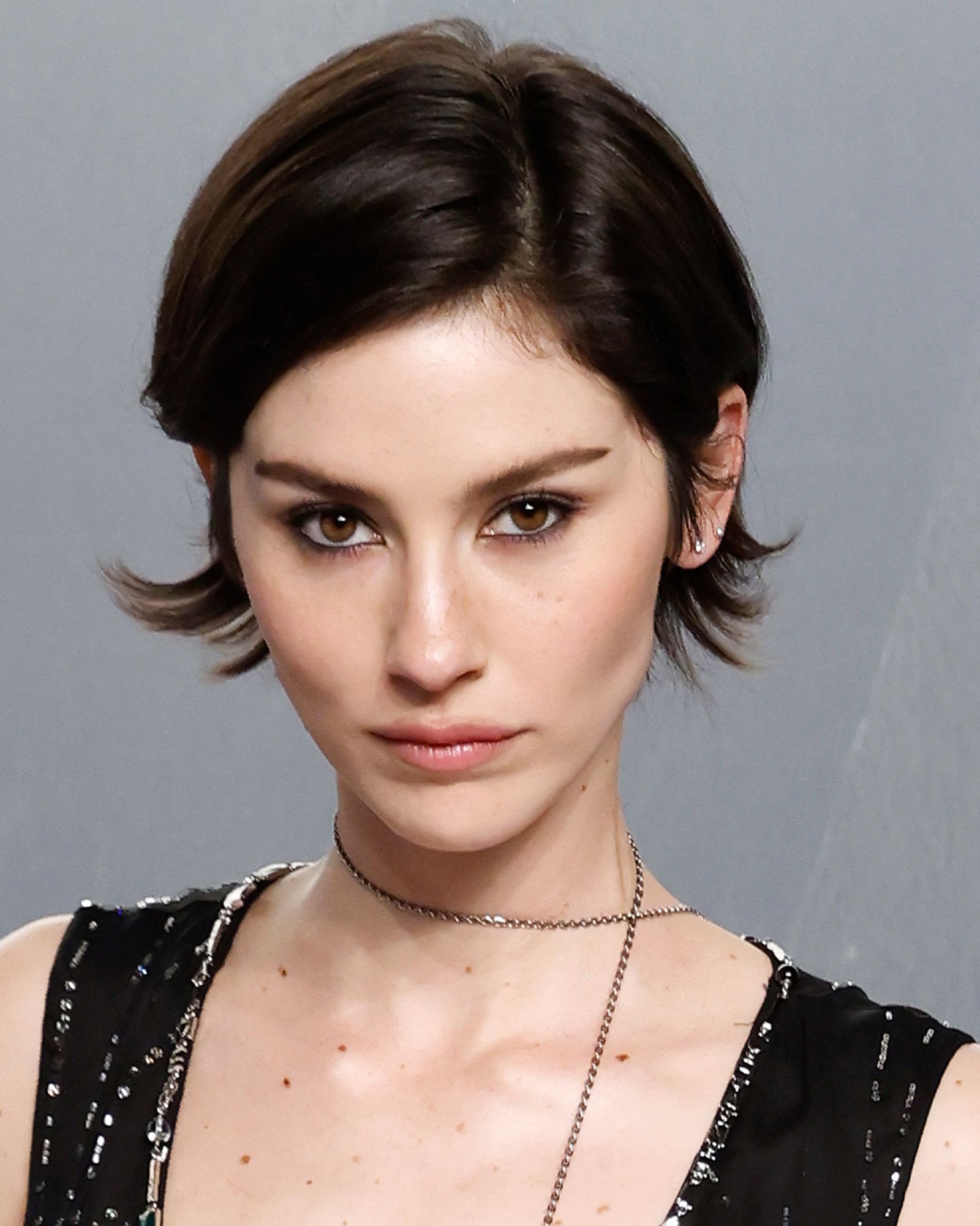 Closeup of a woman with a bixie cut.