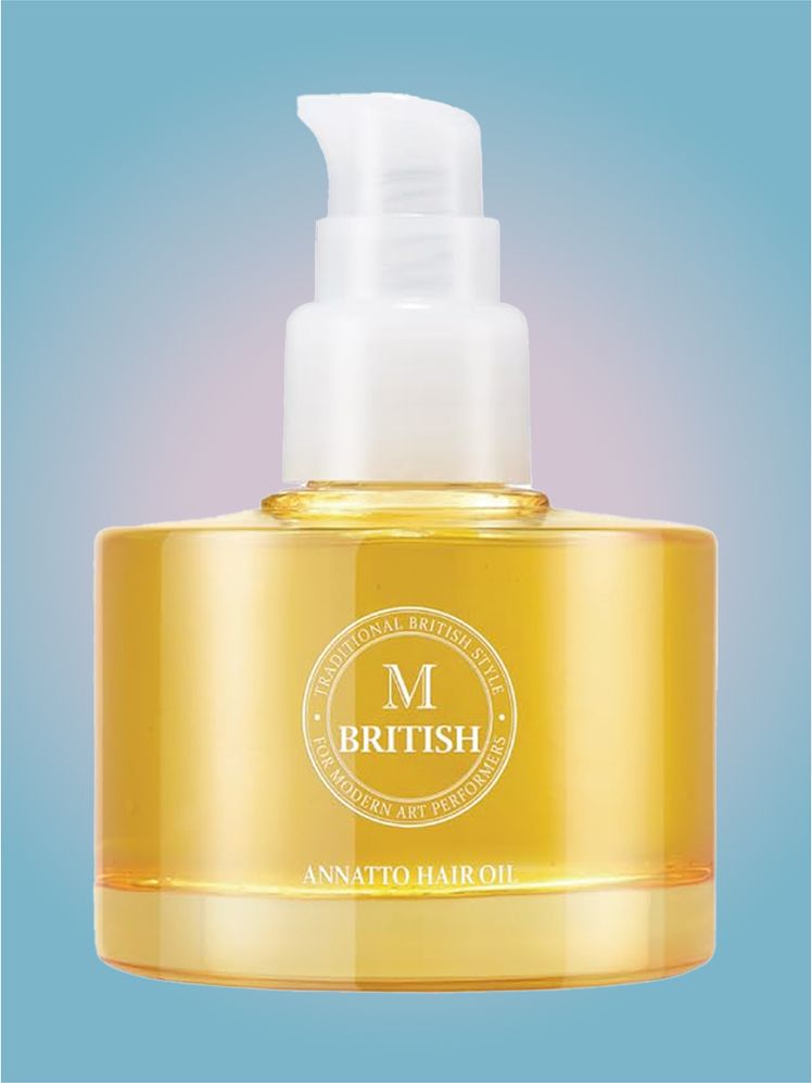 British M Annatto Hair Oil in branded component on a pink and blue background