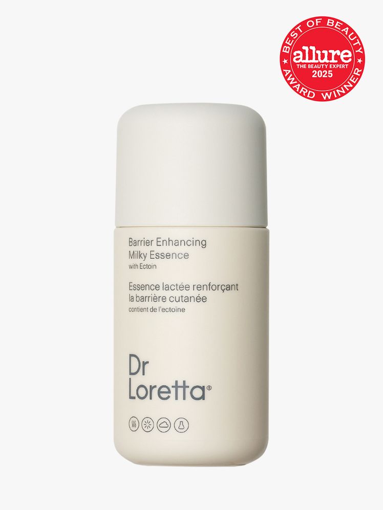 Dr. Loretta Barrier Enhancing Milky Essence in branded white bottle and cap on light gray background with red Allure...