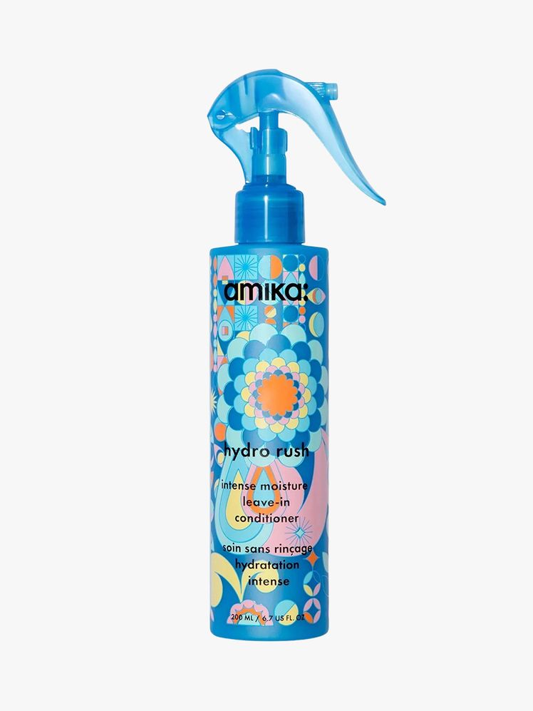 Amika Hydro Rush Intense Moisture Leave-In Conditioner blue spray bottle with top and floral label on light grey background