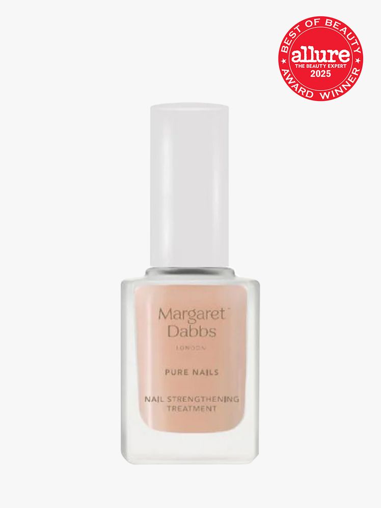 Margaret Dabbs London Nail Strengthening Treatment in branded glass bottle with white cap on light gray background with...