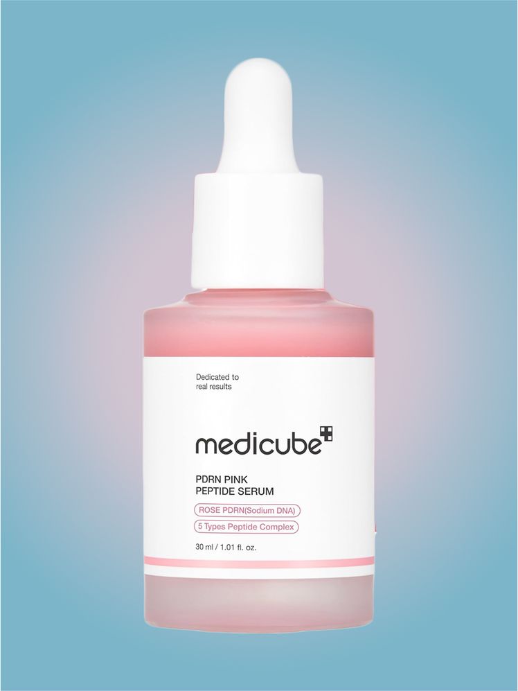 Medicube PDRN Pink Peptide Serum in branded dropper component on a pink and blue component