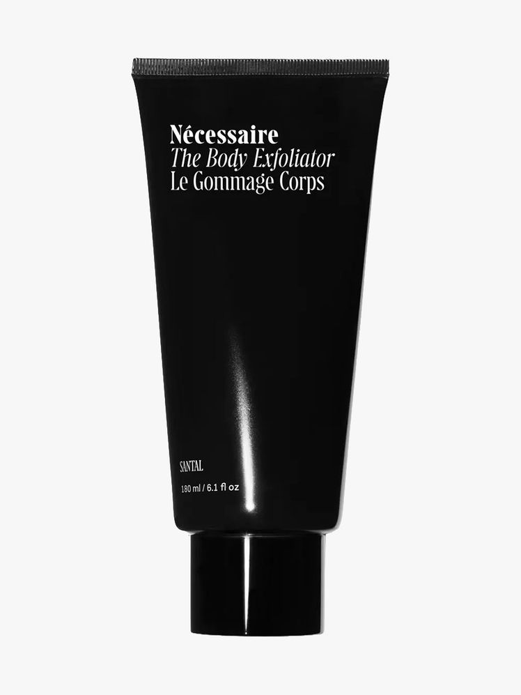 Ncessaire Body Exfoliator in Santal black tube on light gray background