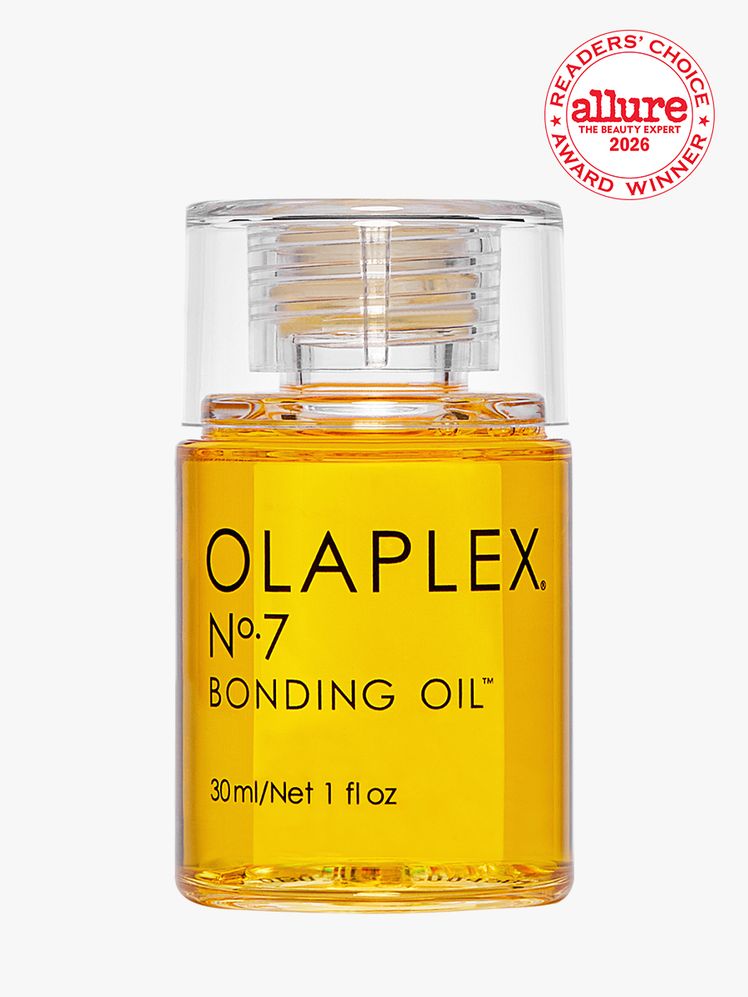 Transparent bottle of OLAPLEX No 7 Bonding Oil on white background