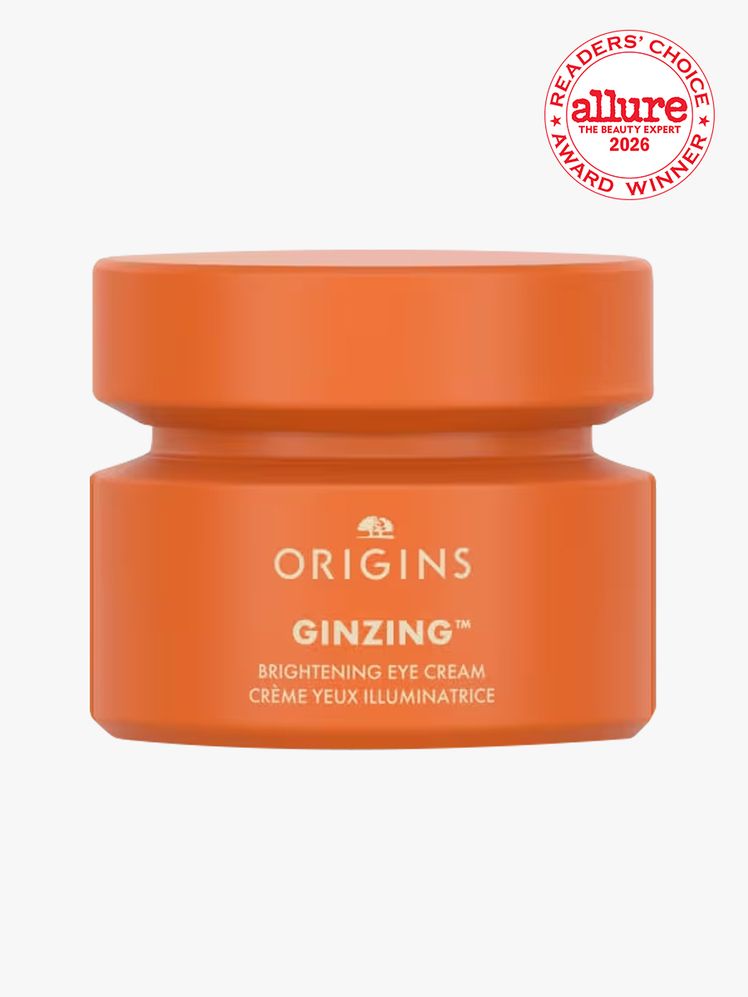Orange container of Origins GinZing Brightening Eye Cream on white background