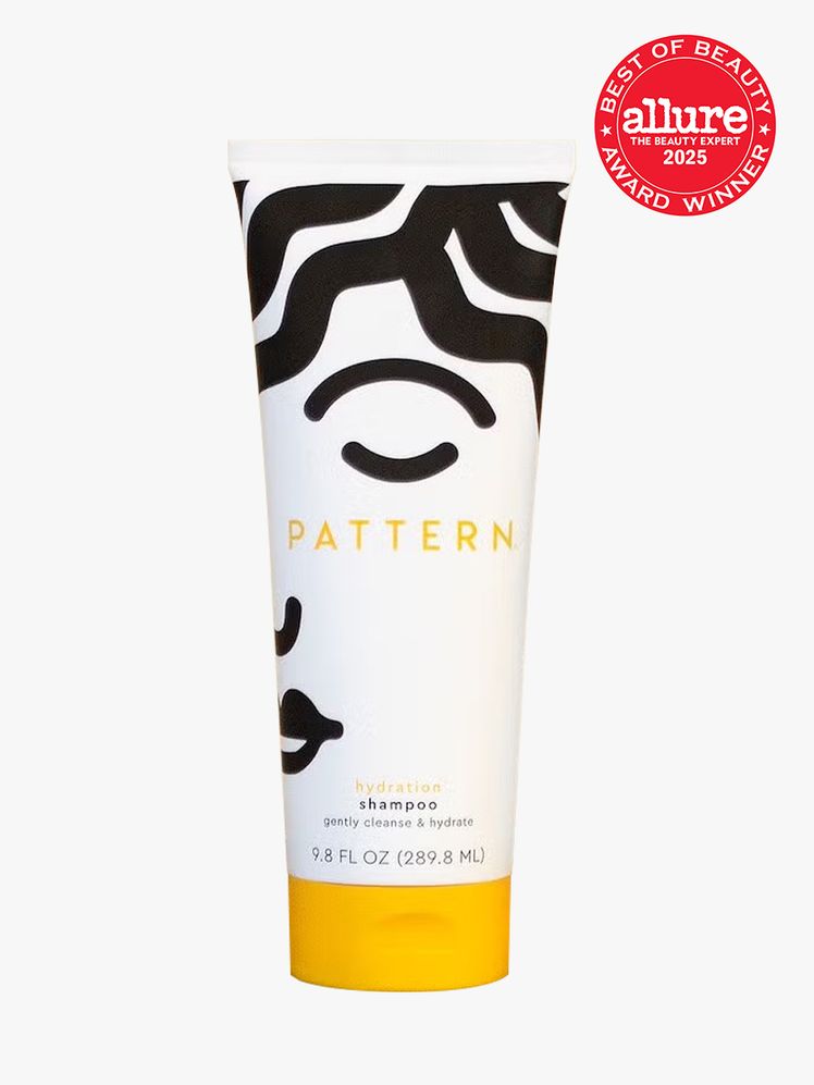 PATTERN Beauty Hydration Shampoo in branded white and black tube with yellow cap on light gray background with red...