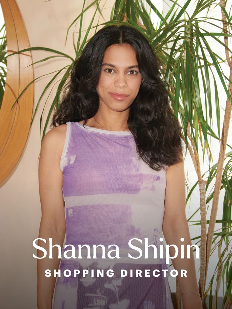 Shanna Shipin Portrait  A brunette woman in a purple outfit stands at the side of a green dress. A mirror is to her...