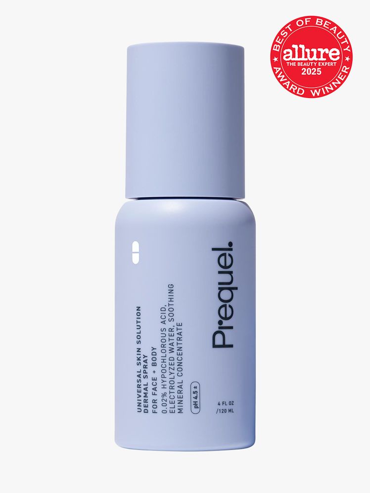 Prequel Universal Skin Solution Dermal Spray in branded periwinkle bottle with cap on light gray background with red...