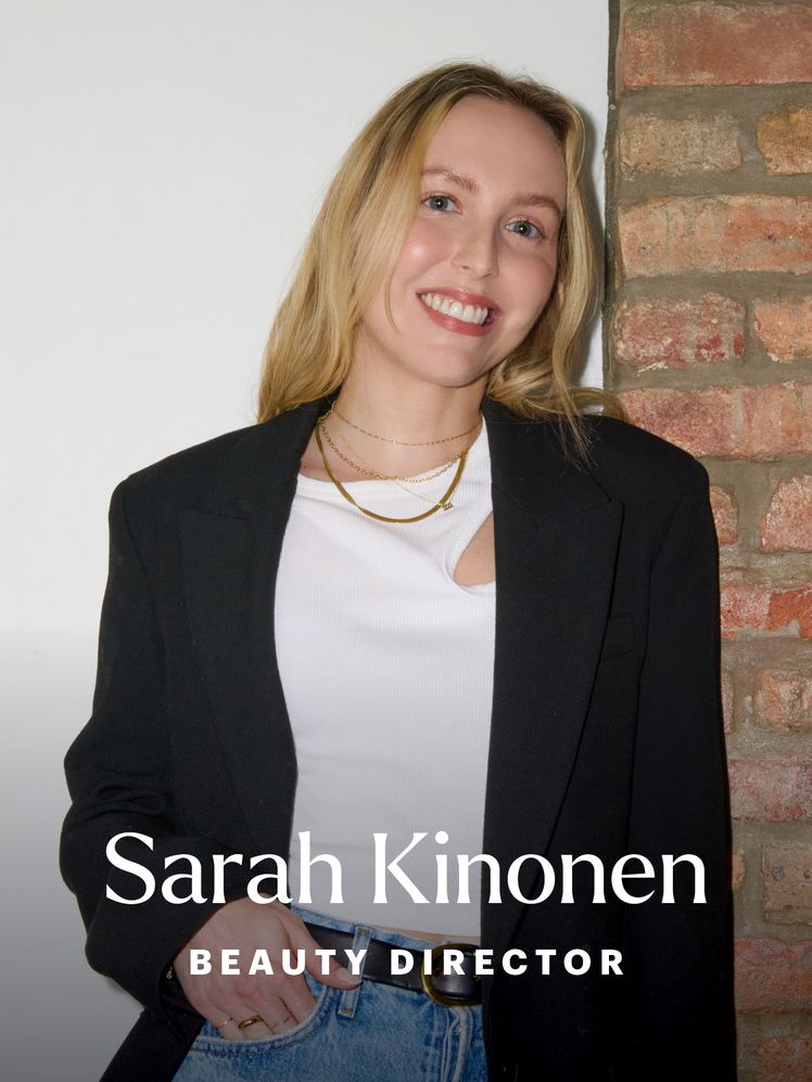 Sarah Kinonen standing in front of a brick wall