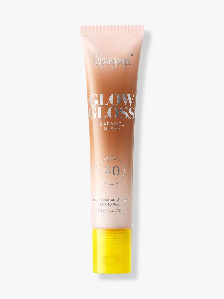 Supergoop Glow Gloss SPF 40 in Caramel Glaze tube of caramel lip gloss with yellow cap on light gray background