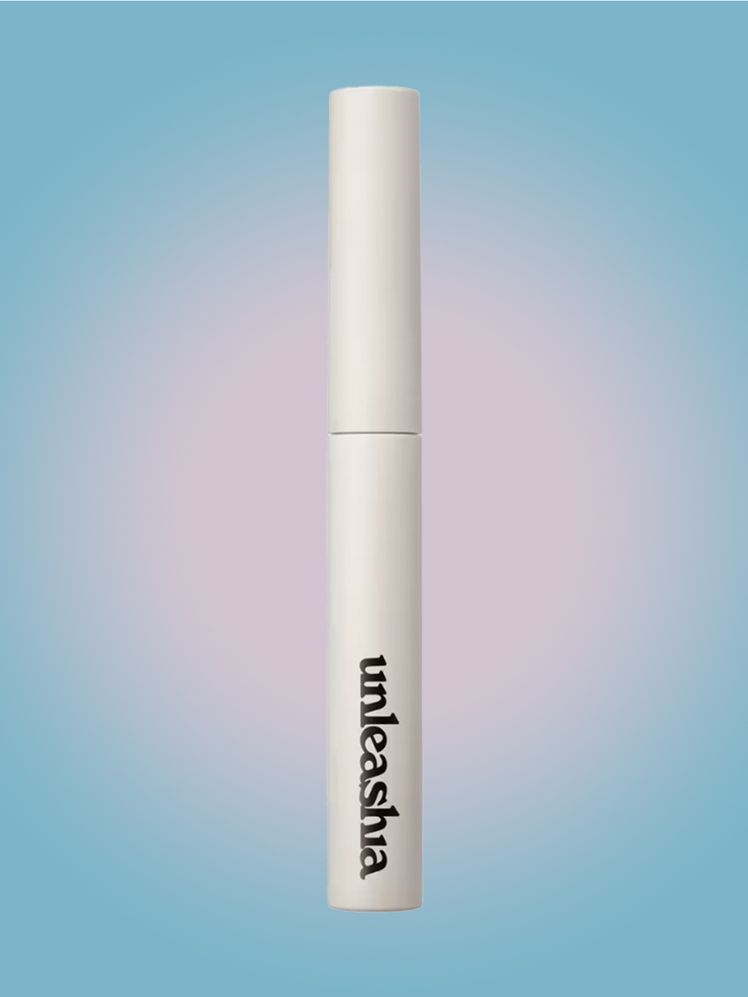 Unleashia Shaper Pomade Eyebrow Fixer brow gel vial on light blue background