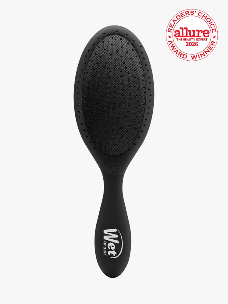 Black detangler brush on white background